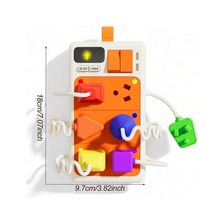 An orange interactive busy board for children featuring lights, sounds, and various puzzle components.