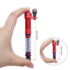 A hand holds an adjustable red aluminum shock absorber, showing its length and mechanism.