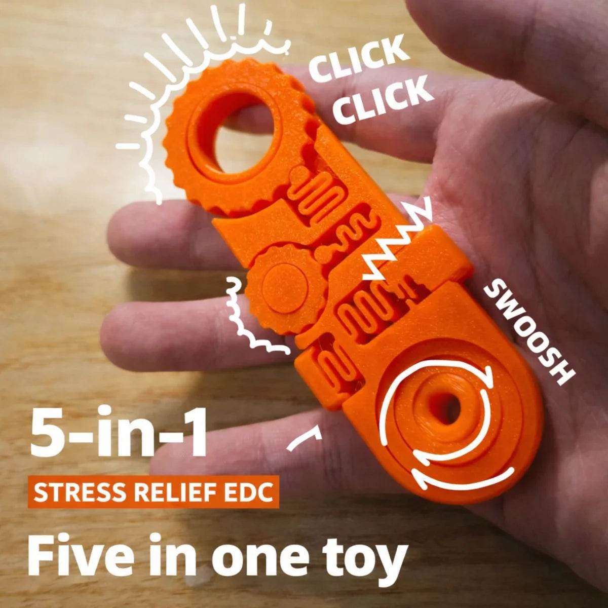 An orange 5-in-1 stress relief EDC toy is held in a hand, showing various click and swoosh mechanisms.