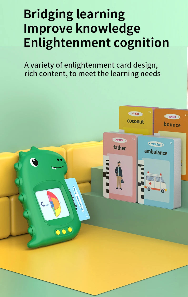 A green interactive learning machine with a screen and cards is displayed on a yellow surface.