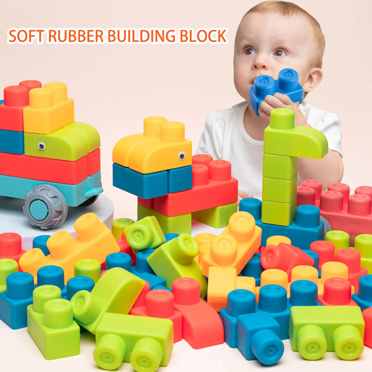 A baby is playing with colorful soft rubber building blocks and puzzles on a white surface.