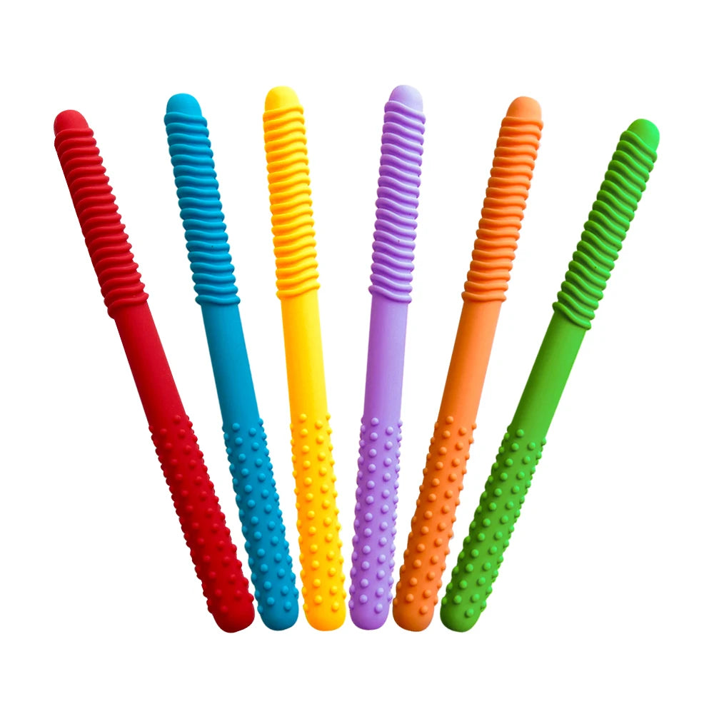 A collection of silicone chewing tubes for kids in various bright colors including red, blue, yellow, purple, orange, and gre