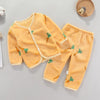A yellow fleece jacket and pants set for a baby with a cartoon print of carrots.
