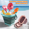 A colorful multifunctional beach bucket toy filled with sand and various plastic scoops for toddlers.