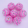 A collection of ten pink and silver glitter resin beads for jewelry making