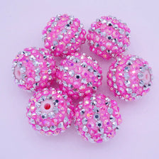 A collection of ten pink and silver glitter resin beads for jewelry making