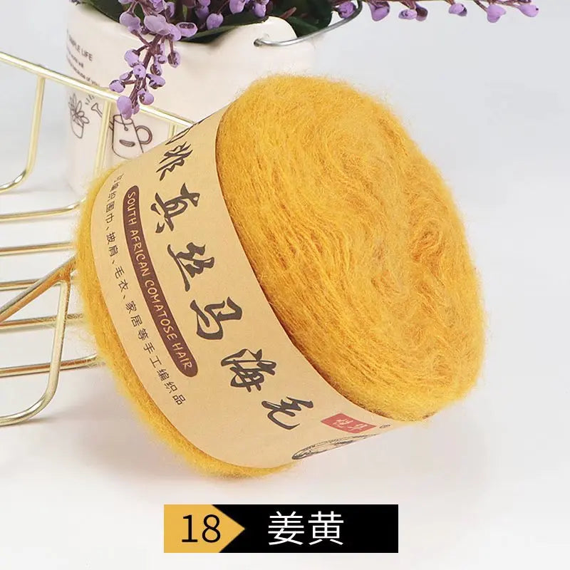 A ball of bright yellow mohair yarn labeled South African mohair for knitting projects.