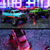 A bright blue 1:64 RC monster truck is shown drifting on a dark surface with red LED lights illuminating the scene.