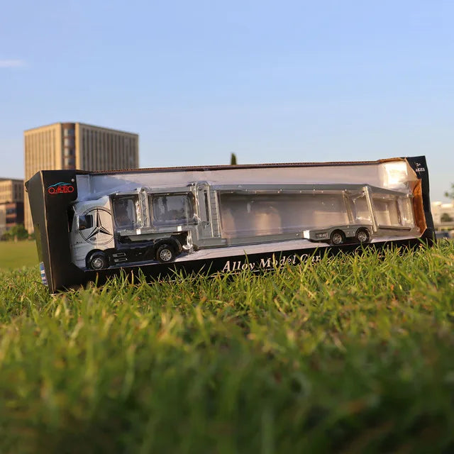 A 1:50 scale diecast alloy container truck model displayed on green grass.