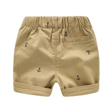 Tan boys cotton beach shorts featuring a subtle anchor print