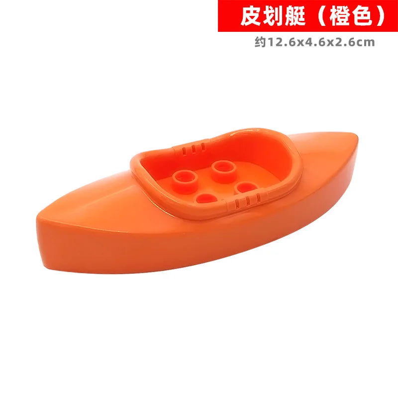 Orange plastic building block set with vehicles and a trailer