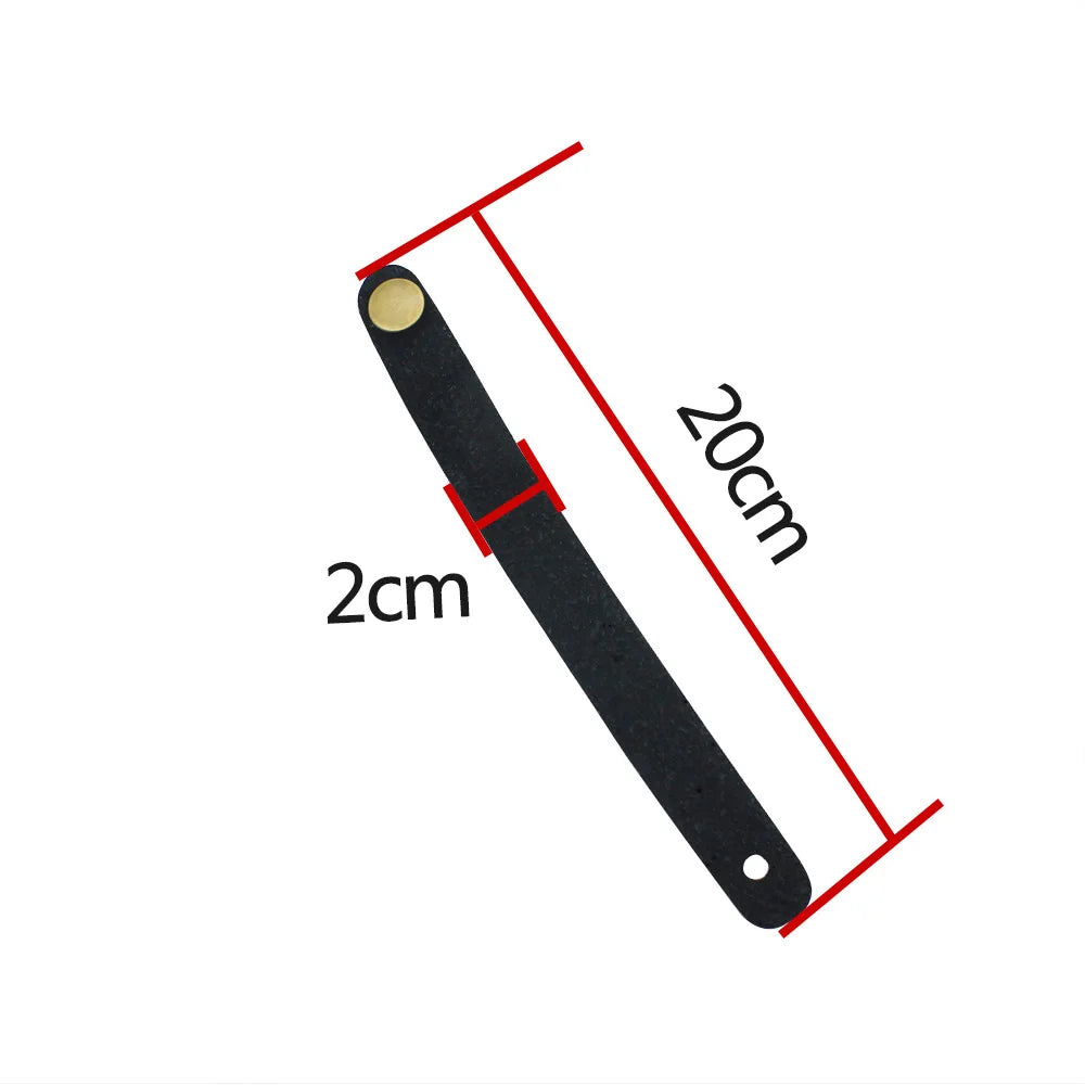 A black leather guitar strap button with a metal fastener, shown with dimensions of 2cm and 20cm.