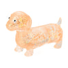 An adorable, squishy stress relief toy shaped like a dachshund, colored in a light orange hue.