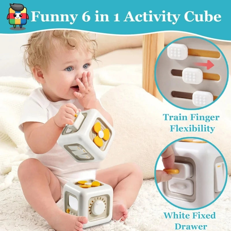 A baby is using a white activity cube that features a finger flexibility trainer and a white fixed drawer.