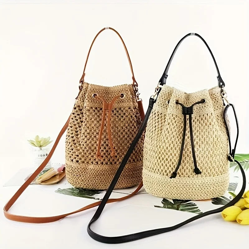 A beige crochet dumpling bag with black hardware and adjustable strap displayed on a white background.
