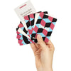 A hand holds several cards from a Couples Edition conversation starter card game featuring geometric designs and the word TAL