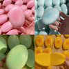 A close-up of various pastel colored cheese-shaped squishy stress relief toys in pink, blue, and yellow.