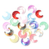A collection of iridescent moon-shaped glass beads in various shades of pink, purple, blue, and green.