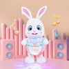 A white musical robot rabbit toy with pink accents standing in front of pink cylindrical blocks and musical notes.