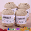 Four skeins of natural beige cotton knitting yarn for crochet and handmade projects