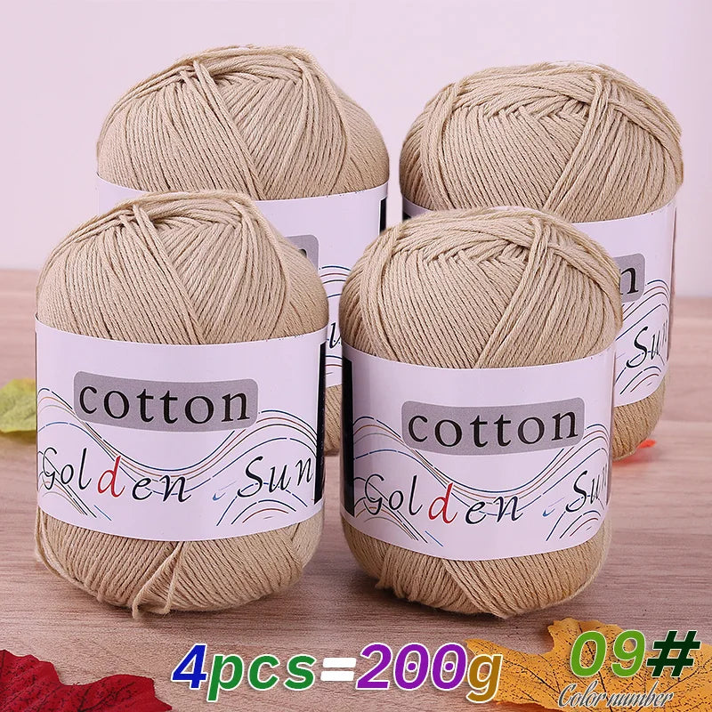 Four skeins of natural beige cotton knitting yarn for crochet and handmade projects