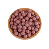 A wooden bowl filled with small, round, pink silicone beads for jewelry making and crafts.
