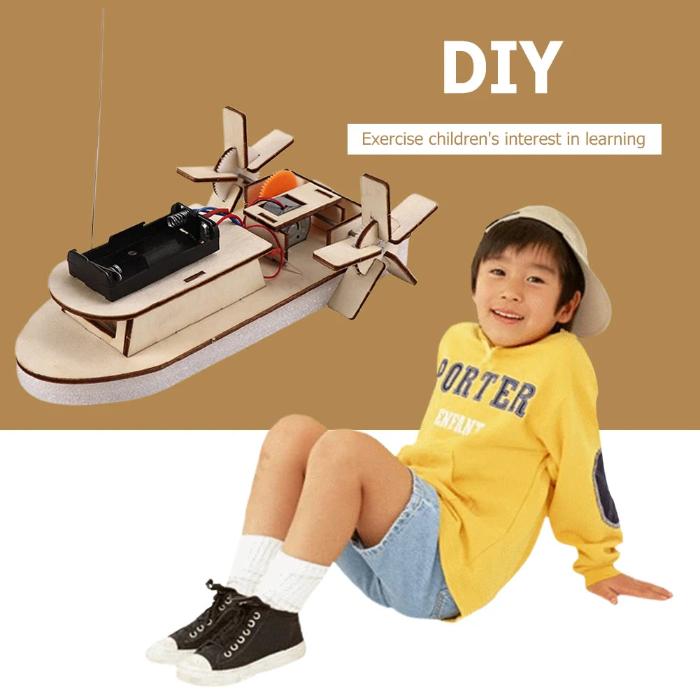 A child is holding a DIY wooden paddle boat kit made of wood and plastic for a science learning activity.