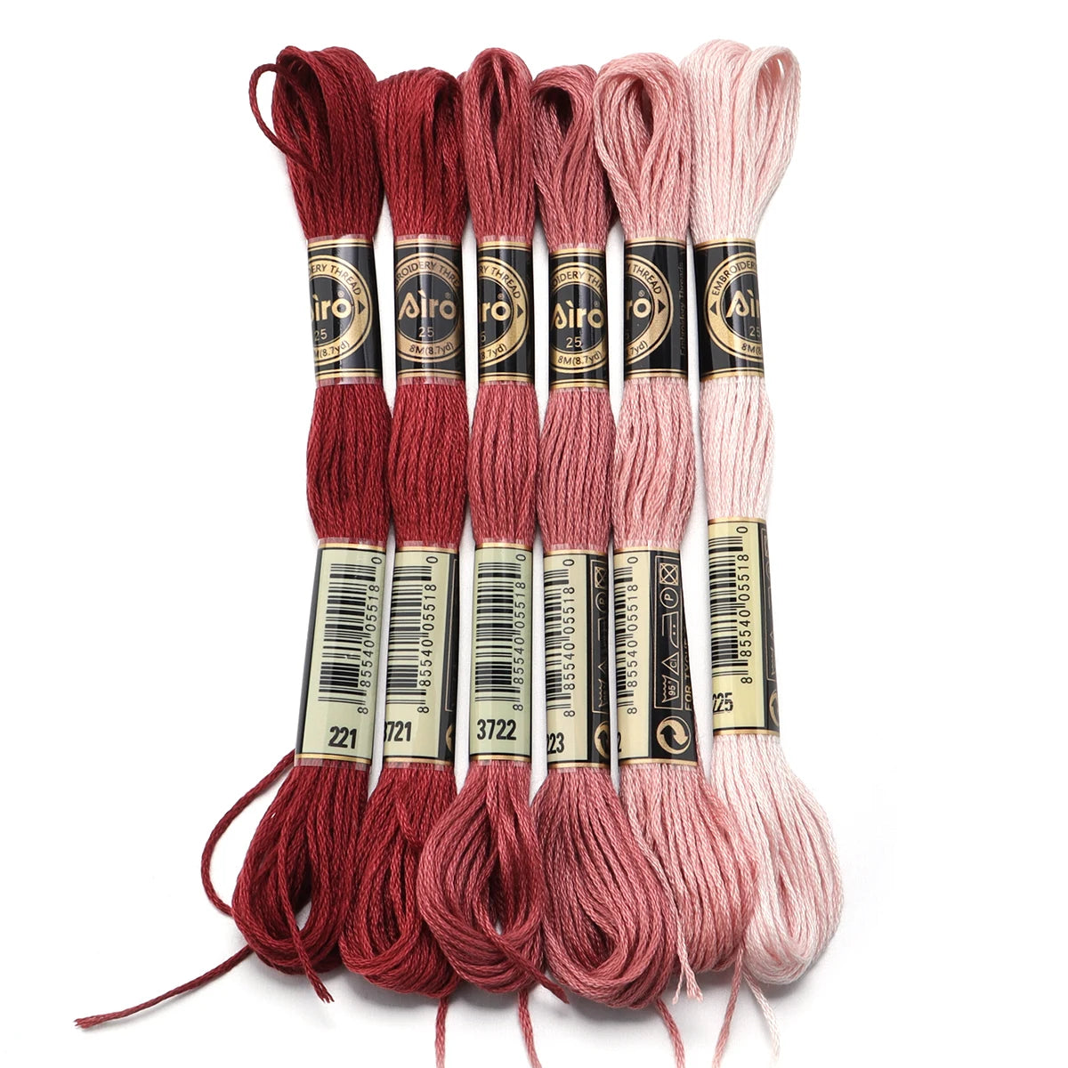 A set of six skeins of vibrant embroidery thread in shades of red, pink, and cream for cross stitch and DIY crafts.