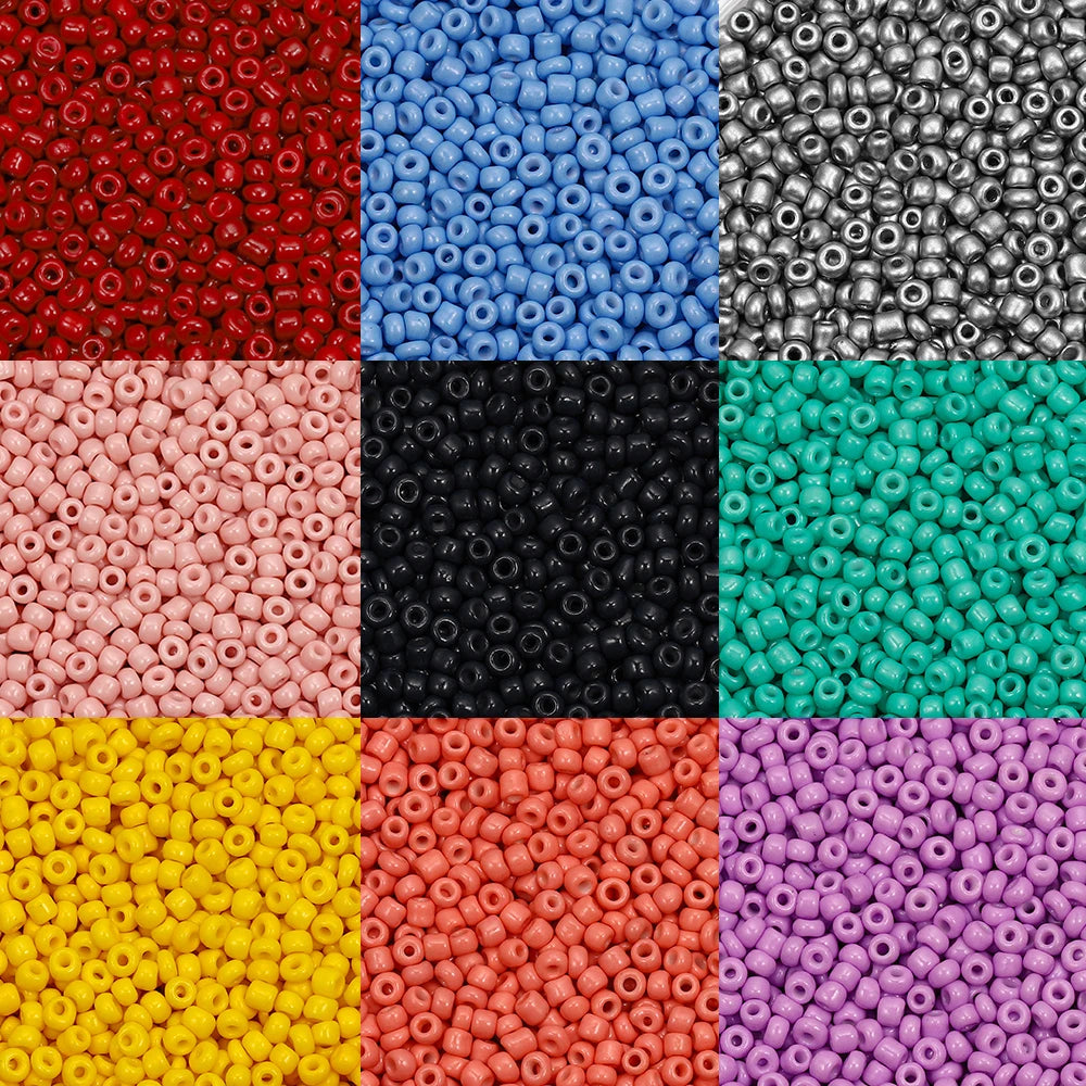 A grid of various colored round glass seed beads for jewelry making including red blue silver black green and yellow