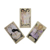A set of tarot cards featuring illustrations of figures and cups for divination and reflection.