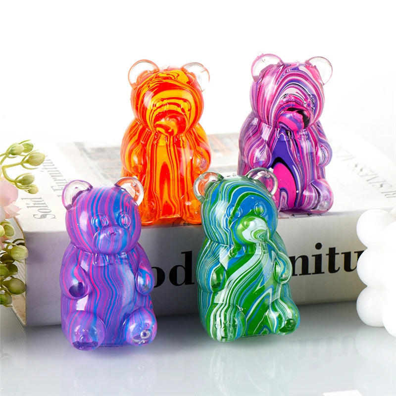 A set of four colorful gummy bear squeeze toys in various shades of orange, pink, purple, and green.