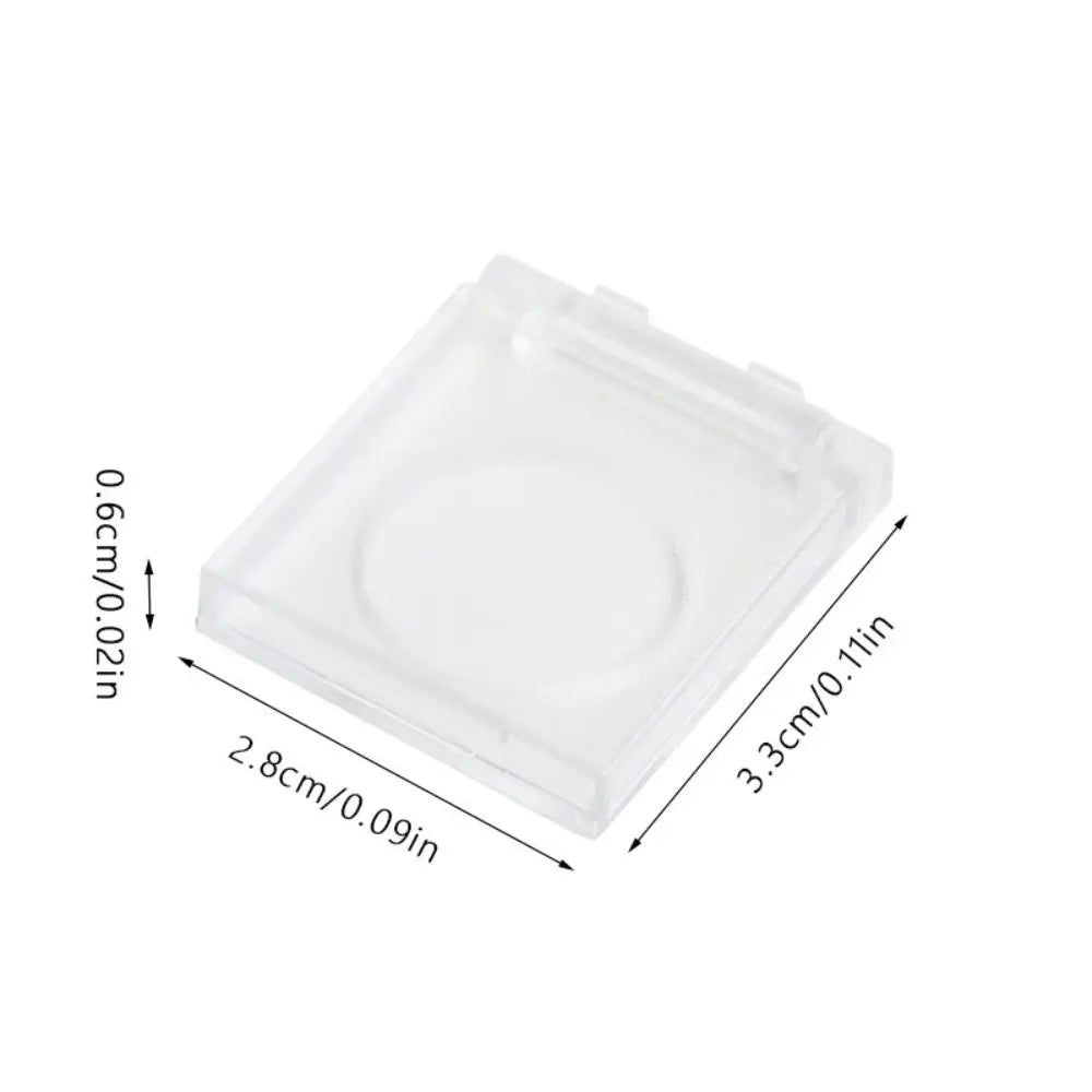 Clear plastic light pad switch protector cover with dimensions 2.8cm by 3.3cm.