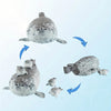 A plush seal family pillow featuring a large adult seal and four baby seals, shown in various angles.