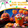 A collection of realistic fake spiders, including orange and green varieties, used for Halloween decorations.