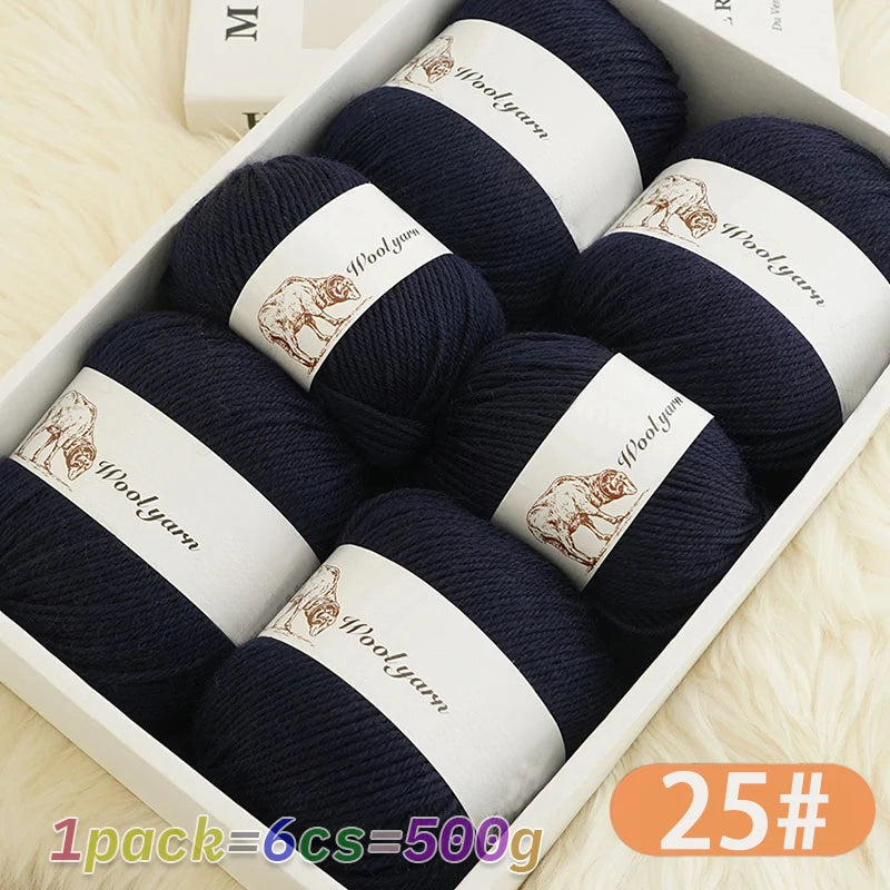 A box of dark navy wool yarn skeins with a label indicating Woolyarn and weight 25#