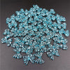 A pile of 20 clear blue acrylic bow beads for jewelry making