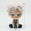 A figure of Tanjiro Kamado from Demon Slayer with light gray hair and orange markings, standing in a seated pose.