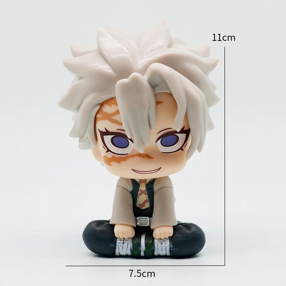 A figure of Tanjiro Kamado from Demon Slayer with light gray hair and orange markings, standing in a seated pose.
