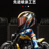 A detailed miniature collectible of a motorcycle with an orange and blue helmet displayed against a dark background.