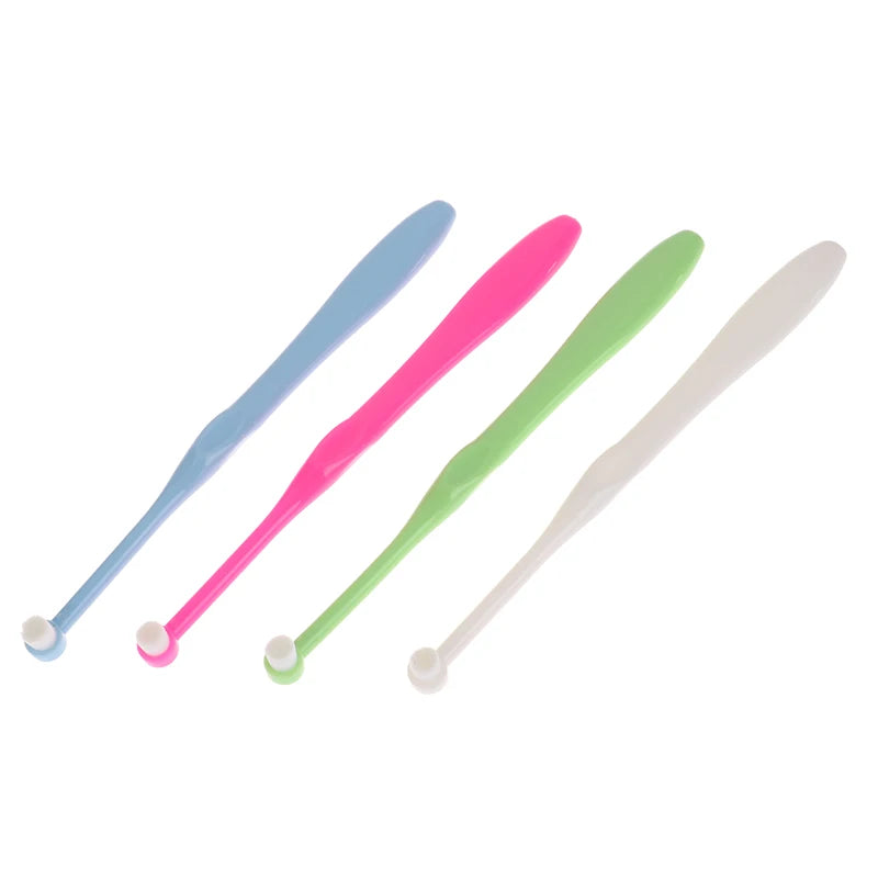 A set of four orthodontic interdental brushes in blue, pink, green, and white.