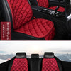 A set of red quilted car seat cushions and backrests for winter warmth.