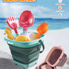 A colorful multifunctional beach bucket toy with pink and orange utensils is shown on a sandy surface.
