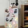 A silver suitcase decorated with various cute cartoon cat stickers on its surface.