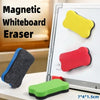 A magnetic whiteboard eraser set showing yellow, red, and green erasers on a white board.
