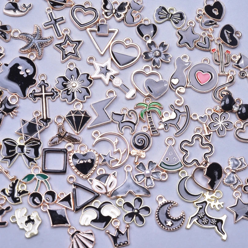 Assortment of gold-tone enamel charms for jewelry making featuring various shapes and designs