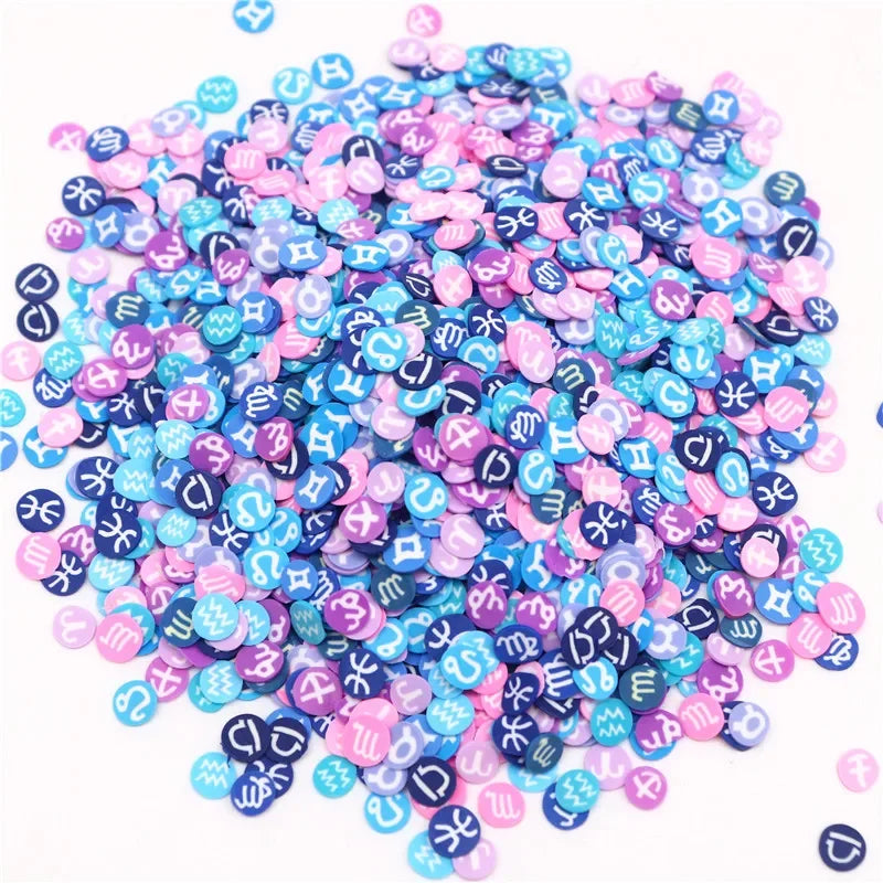 A pile of colorful polymer clay flower charms in various shades of pink, blue, and purple.
