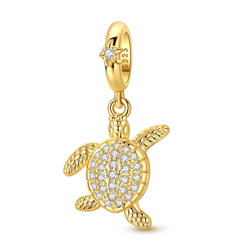 Gold-tone charm pendant set featuring starfish, sea turtle, and whale shark charms.