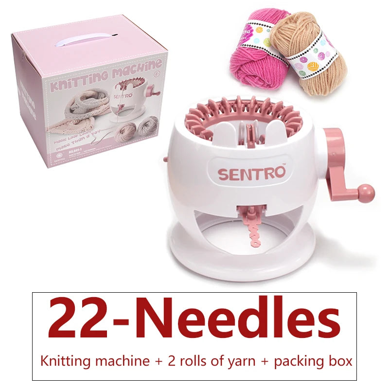 A white hand-operated knitting machine with a pink yarn ball and a spool of yarn, along with its packaging box.