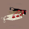 A handmade strawberry crochet headband featuring red and white fabric flowers on a beige background.