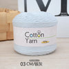 A ball of light blue cotton yarn labeled Cotton Yarn 100g with a measurement of 03 CM/silver thread.